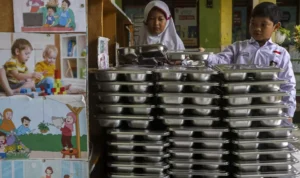 Image Credit Angga Budhiyanto/Antara - Children return the food trays used by the government-aided free meals at an elementary school in Banten on Feb. 18, 2025.