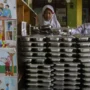 Image Credit Angga Budhiyanto/Antara - Children return the food trays used by the government-aided free meals at an elementary school in Banten on Feb. 18, 2025.