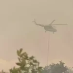 Image Credit Fuad Iqbal Abdullah/B-Universe - A helicopter belonging to the National Disaster Mitigation Agency (BNPB) conducts an aerial firefighting operation in the South Kalimantan town of Banjarbaru, Friday, Aug. 18, 2023.