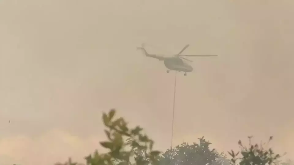 Image Credit Fuad Iqbal Abdullah/B-Universe - A helicopter belonging to the National Disaster Mitigation Agency (BNPB) conducts an aerial firefighting operation in the South Kalimantan town of Banjarbaru, Friday, Aug. 18, 2023.