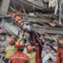 Image Credit AP - Chinese search and rescue team members moved a victim from a building that collapsed after the Myanmar earthquake in Mandalay on Monday, March 31, 2025.